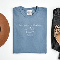 a t - shirt that says the lord is my shepherd next to some shoes and a hat