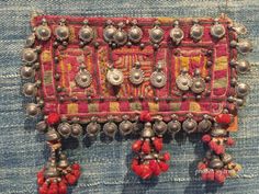 a piece of cloth with beads and tassels on it