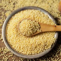 sesame seeds in a bowl with a wooden spoon