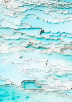 the water looks like it is melting in some kind of icey pool that's blue and white