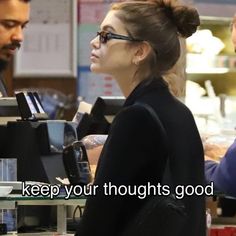 a woman standing in front of a cash register with another man behind her and the words keep your thoughts good