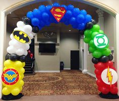 an arch decorated with balloons and superman symbols