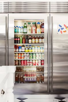 a stainless steel refrigerator with drinks in it