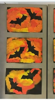 four paintings with bats painted on them in orange, yellow and black colors are hanging on the wall