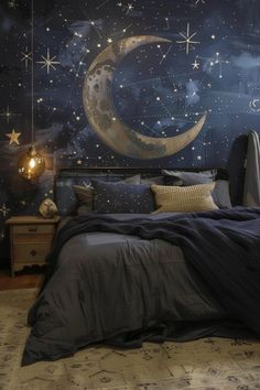 a bedroom decorated in blue and gold with stars on the wall, moon and crescent