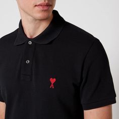 No wardrobe is complete without a black polo shirt. This one from AMI is made from breathable organic cotton and embroidered with the brand's iconic de Coeur emblem comprising of an 'A' and floating heart..Style Notes:.AMI De Coeur polo shirt.Black organic cotton.100% organic cotton.Spread collar, embroidered logo.Machine wash.Made in Portugal.Size & Fit:.Fits true to size.Button fastenings along front.Mid-weight fabric, slight stretch Fitted Casual Polo Shirt With Embroidered Logo, Red Polo Shirt, Black Polo Shirt, Ootd Men, Black Polo, Cotton Polo Shirt, Cotton Polo, Black Shirt, Floating