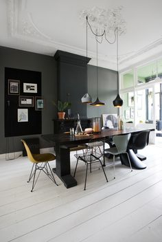 a dining room table with chairs and lights