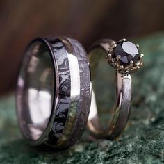 two wedding rings with black diamonds on them