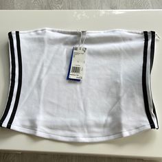 New Adidas White Black Stripe Bandeau Top Strapless. Size Large. Side Zipper. Easy To Put On And Remove. Length: Approx 11.5”. Armpit To Armpit: Approx 18”. White Bandeau Tank Top, Trendy White Strapless Tank Top, White Cotton Sleeveless Tube Top, Sporty Stretch Strapless Tube Top, Sporty Strapless Stretch Tube Top, White Cotton Strapless Tube Top, White Strapless Cotton Tube Top, White Strapless Cotton Crop Top, White Stretch Bandeau Tops