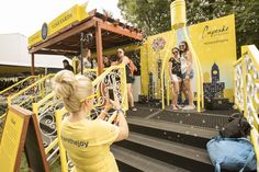 people are standing on the steps near a yellow display