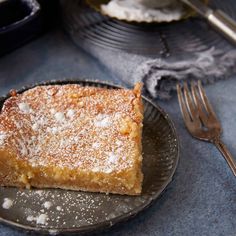 a piece of cake sitting on top of a black plate