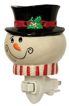 a snowman light with a hat and scarf on it's head