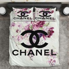 a chanel bed set with pink flowers on it