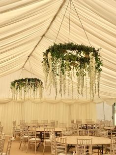 the inside of a tent with tables and chairs