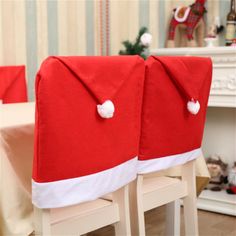 two red and white chairs with santa hats on them