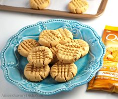 cookies on a blue plate next to a bag of oatmeal crackers