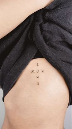 the back of a woman's stomach with words written on it that say i love mom