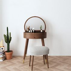 a vanity table with a stool and potted plants