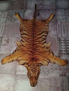 a tiger skin rug is laying on the floor