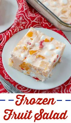 frozen fruit salad on a white plate with a red and white table cloth next to it