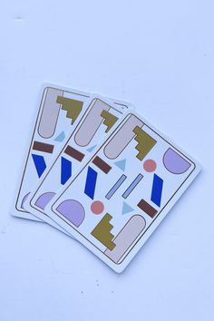 two stickers with shapes on them sitting next to each other in front of a white background