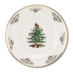 a white plate with a green christmas tree on the front and gold trimmings