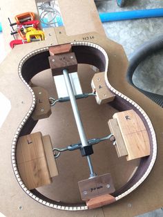 the guitar is being built and ready to be worked on with some woodworking tools