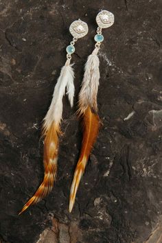 "These sterling silver feather earrings to die for! I've always been inspired by feathers. Feathers have been used throughout history to represent truth, freedom, honor, and integrity. When you put these earrings on, I hope you to feel like the free woman you are. Sometimes we don't always feel that way, but we are the only ones to set ourselves free.  These boho earrings are so lightweight, unique & cool. Compliments will be coming your way when you wear them!  Aquamarine represents feminine wisdom, being in flow with the tides of life and surrendering to the natural order of what is so we can be present and have abundance right now! ▲ Carved Evil Eye Sterling Silver post back ▲ Aquamarine crystal  ▲ 4-5\" natural feathers ▲ Weight: .06 oz ▲ Drop length approximately 6\" ▲ Handmade in Ari Elegant Feather Dangle Jewelry, Elegant Silver Feather Earrings, Sterling Silver Feather Earrings Gift, Elegant Sterling Silver Feather Jewelry, Boho Bridal Earrings, Free Woman, Feather Earrings Silver, In Flow, Aquamarine Crystal