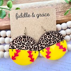 a pair of yellow and red earrings with leopard print