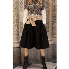 Heavier Weight Fabric With A Pleated Front And Classic Wide-Leg Gaucho Fit. Hidden Back Zipper With Attached Ribbon Belt And Side Pockets. 50 Wool, 50 Polyester Measurements (S): L: 29" W: 28" I.S.: 14" Black Elastic Waistband Culottes For Spring, Chic Non-stretch Knee-length Bottoms, Chic Wide-leg Fall Culottes, Chic Black Culottes For Spring, Chic Black Spring Culottes, Chic Black Belted Wide Leg Pants, Chic Winter Bottoms For Day Out, Black Culottes For Workwear In Spring, High-waisted Culottes With Pockets For Fall