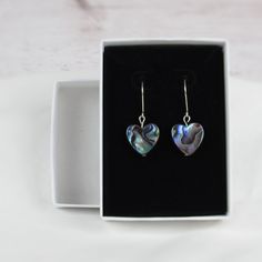 Beautiful shape and shells in our abalone heart dangle earrings! You'll love the gorgeous pop of green and blue these earrings display. A perfect gift for Valentines or just because! Please note, all abalone shells vary. The colors include dark and light blues, greens and hints of purple, reds, and browns. Patterns vary from simple to complex swirls, stripes, and anything between! Get these earrings in the perfect light and the colors will shine and glow beautifully! Materials: sterling silver w Gift Shell-shaped Mother Of Pearl Earrings, Gift Abalone Shell Earrings, Gift Abalone Shell Earrings For Pierced Ears, Abalone Shell Earrings For Pierced Ears As A Gift, Shell-shaped Mother Of Pearl Earrings For Gift, Nickel-free Shell-shaped Earrings Gift, Abalone Shell Drop Earrings For Gift, Nickel-free Abalone Shell Earrings For Gift, Mother Of Pearl Earrings As Gift