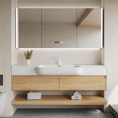 a bathroom with a sink, mirror and towels on the shelf in front of it