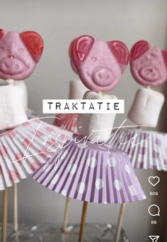 there are some pink and white cake pops on top of each other, with the words traktatie above them