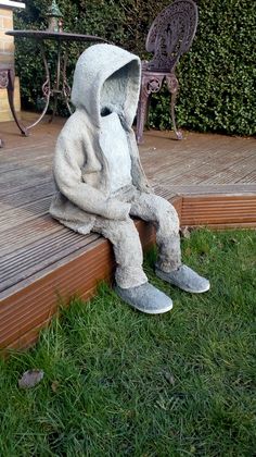 a stuffed animal sitting on top of a wooden deck