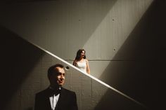 a man in a tuxedo standing next to a woman