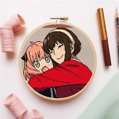 a cross stitch pattern with an image of two people hugging each other and some crayon pencils next to it