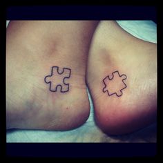 two people with matching tattoos on their feet, one has a puzzle piece in the middle