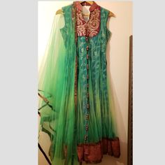 Gorgeous Green And Red Long Anarkali Dress Sleeveless Size Small Having Net Overlay Comes With Red Patchwork Hem Comes With Green Shawl (Dupatta) Brand New Festive Sleeveless Chanderi Dress, Traditional Sleeveless Cutdana Dress, Sleeveless Chanderi Anarkali Dress, Chanderi Sleeveless Dresses For Festivals, Semi-stitched Sleeveless Chanderi Dress, Festival Sleeveless Chanderi Dresses, Traditional Sleeveless Navratri Dresses, Sleeveless Cutdana Kurta For Festivals, Traditional Green Sleeveless Dress