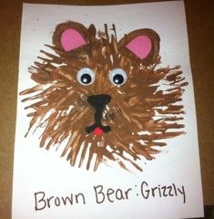 a brown bear grizzly handprint on a white paper with the words brown bear grizzly