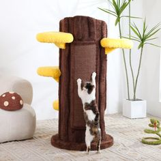 a cat climbing up the side of a tall scratching tower on top of a carpeted floor