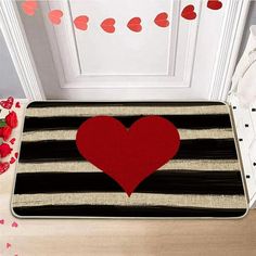 a door mat with a red heart on it