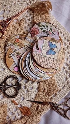 a pile of paper and scissors on top of a doily