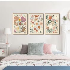 three paintings on the wall above a bed