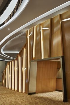 the inside of a building with wood paneling on the walls and ceiling, along with carpeted floors