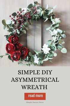 a simple diy asymmetrical wreath with red and white flowers on it