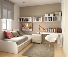 a small bedroom with a bed, desk and bookshelves on the wall above it