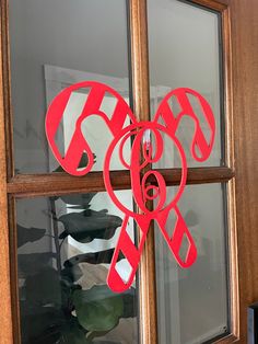 a pair of scissors cut out of paper on a window sill