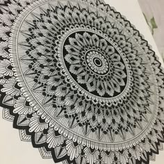 an intricate black and white drawing on paper