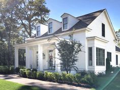 a white house with black shutters on the front