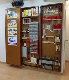 the inside of a storage cabinet with tools in it